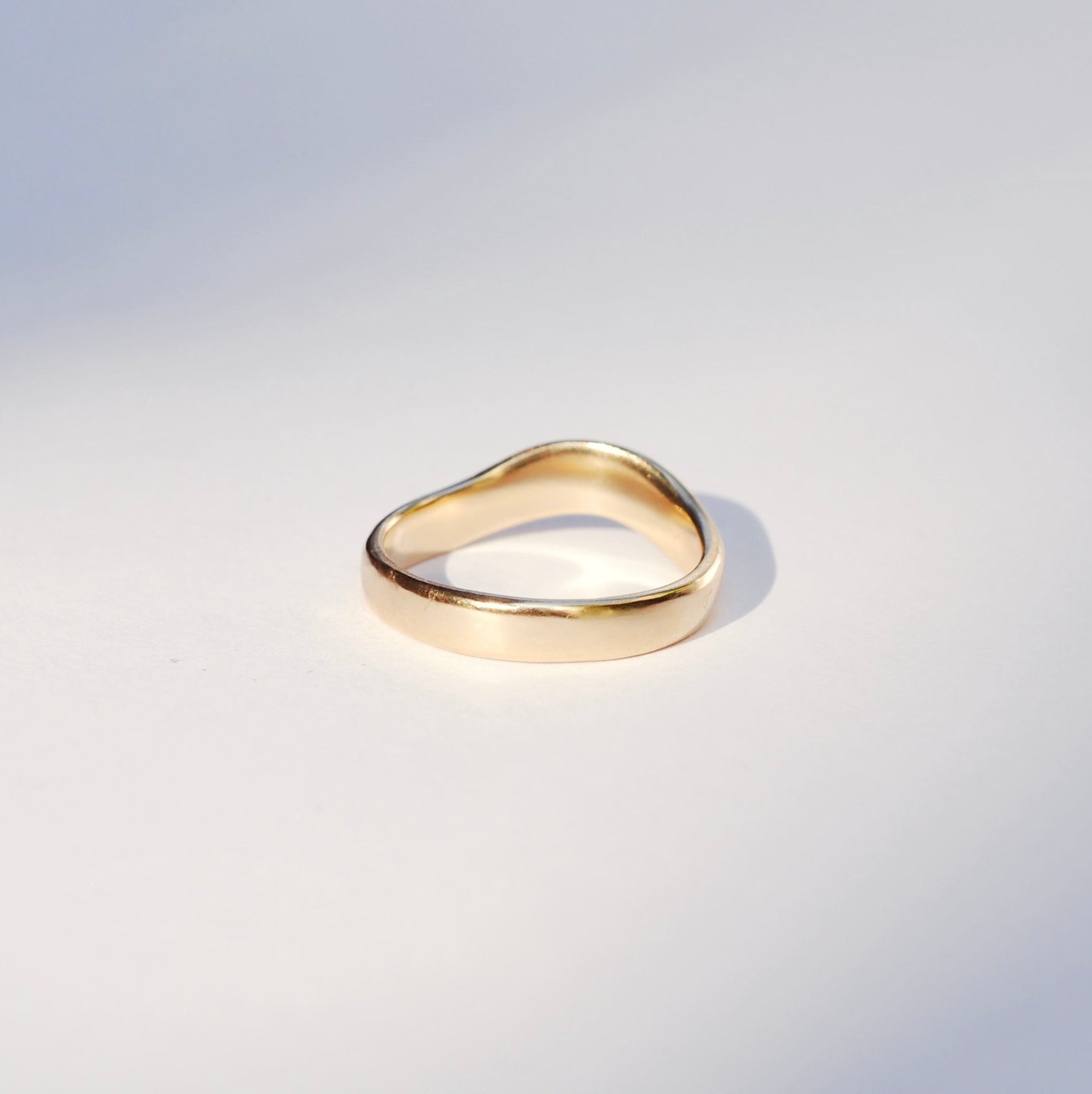 Gold ring on a light gray background