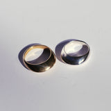 Top view of view rings, one bronze and one silver with a tall profile and a knife edge