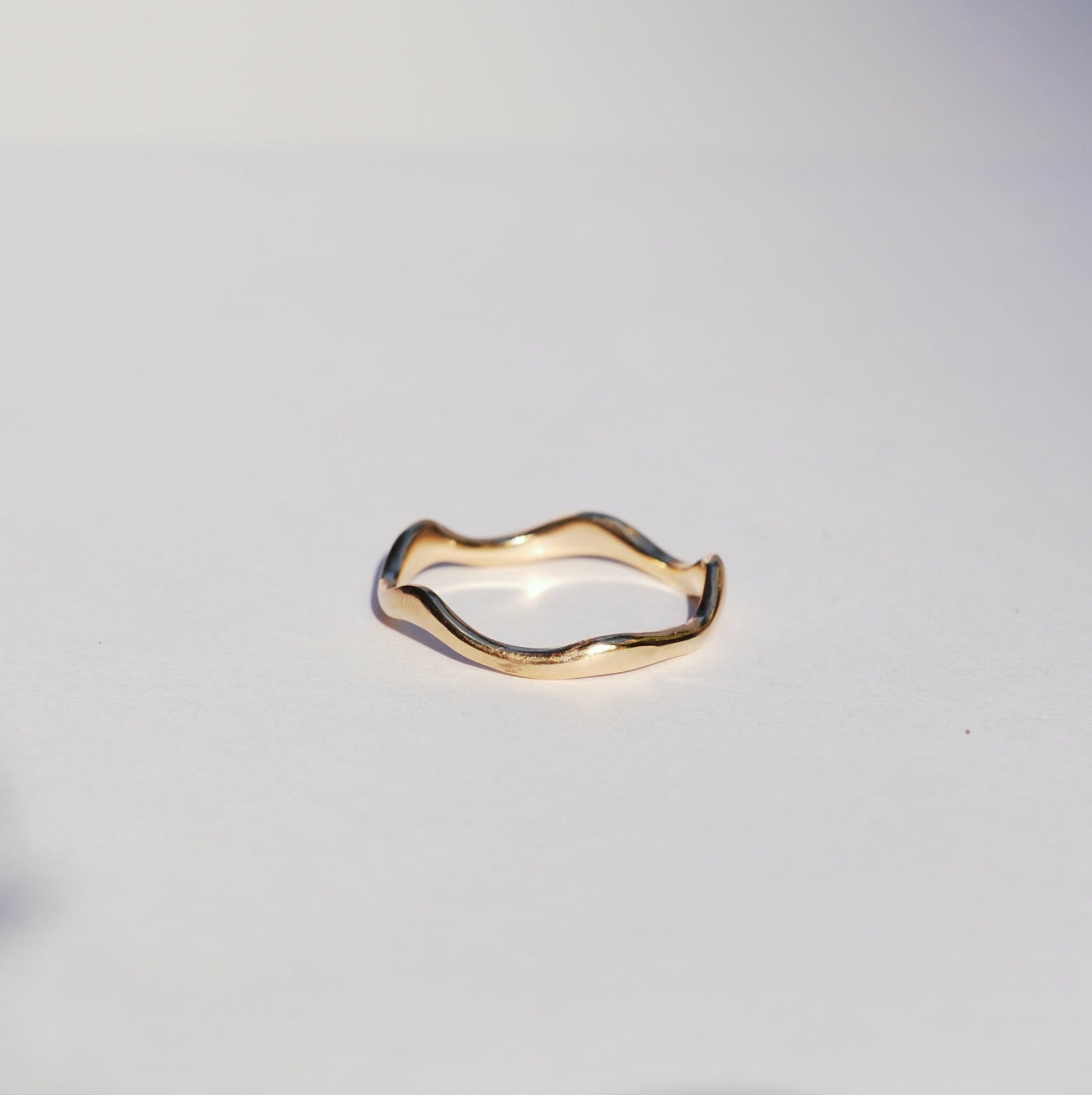Gold ring on a white background with a soft focus effect