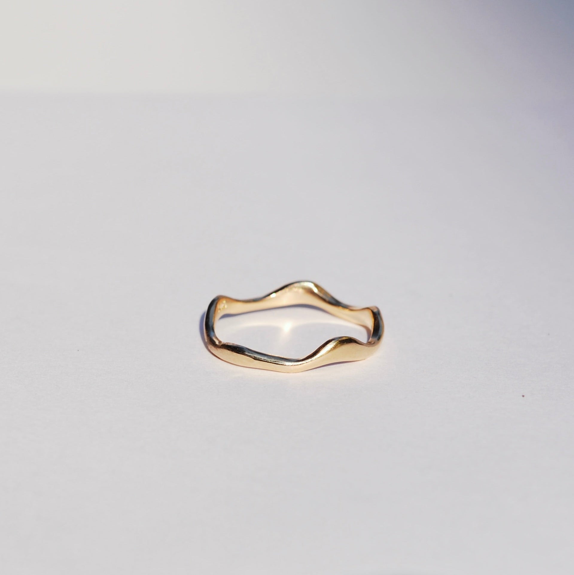 Gold ring on a light gray background