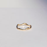 Gold ring on a light gray background