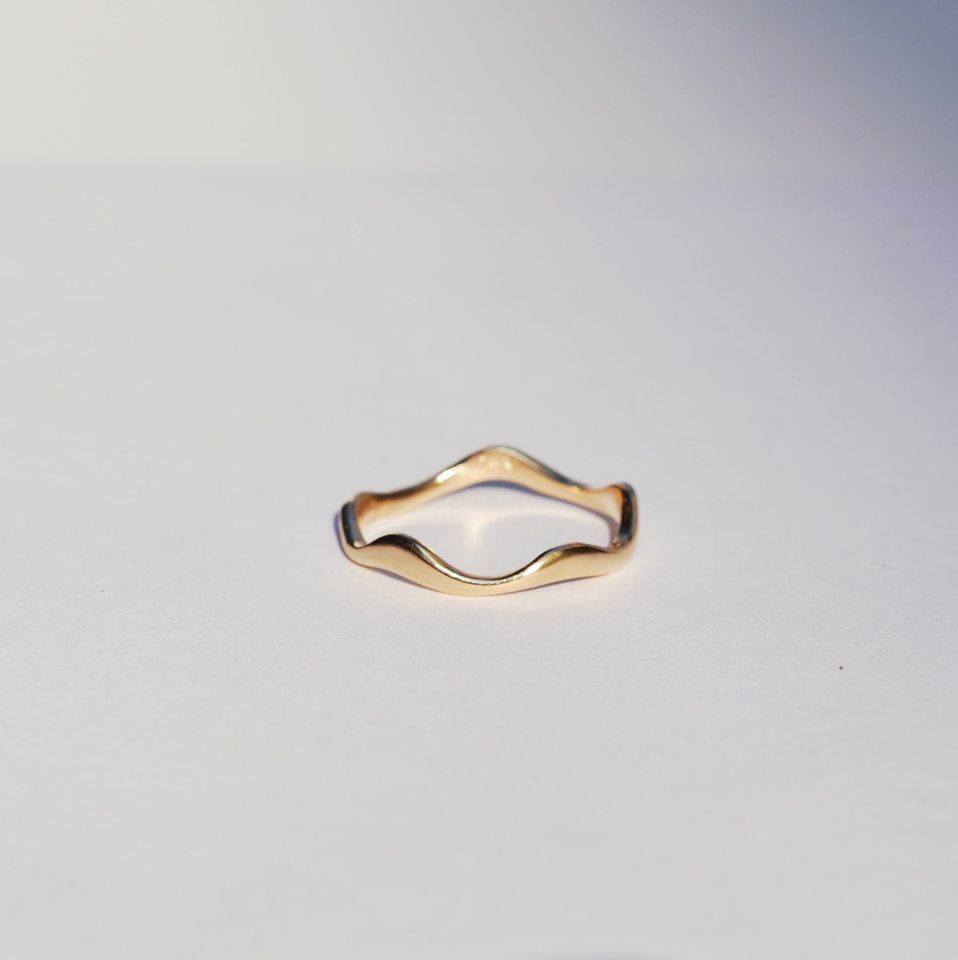 Gold ring on a light gray background