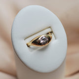 Gold ring with a champagne colored zircon on a white cushion