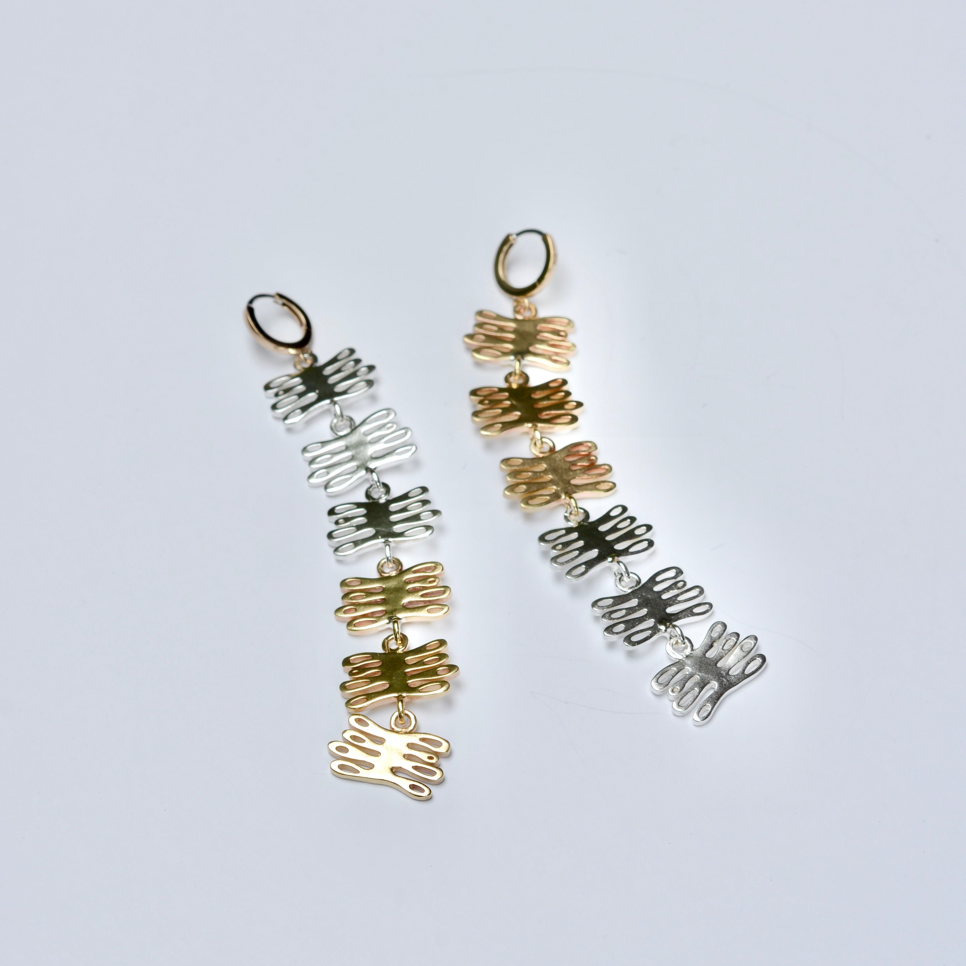 Long bronze and silver mixed metal huggie earrings made of coral shaped charms