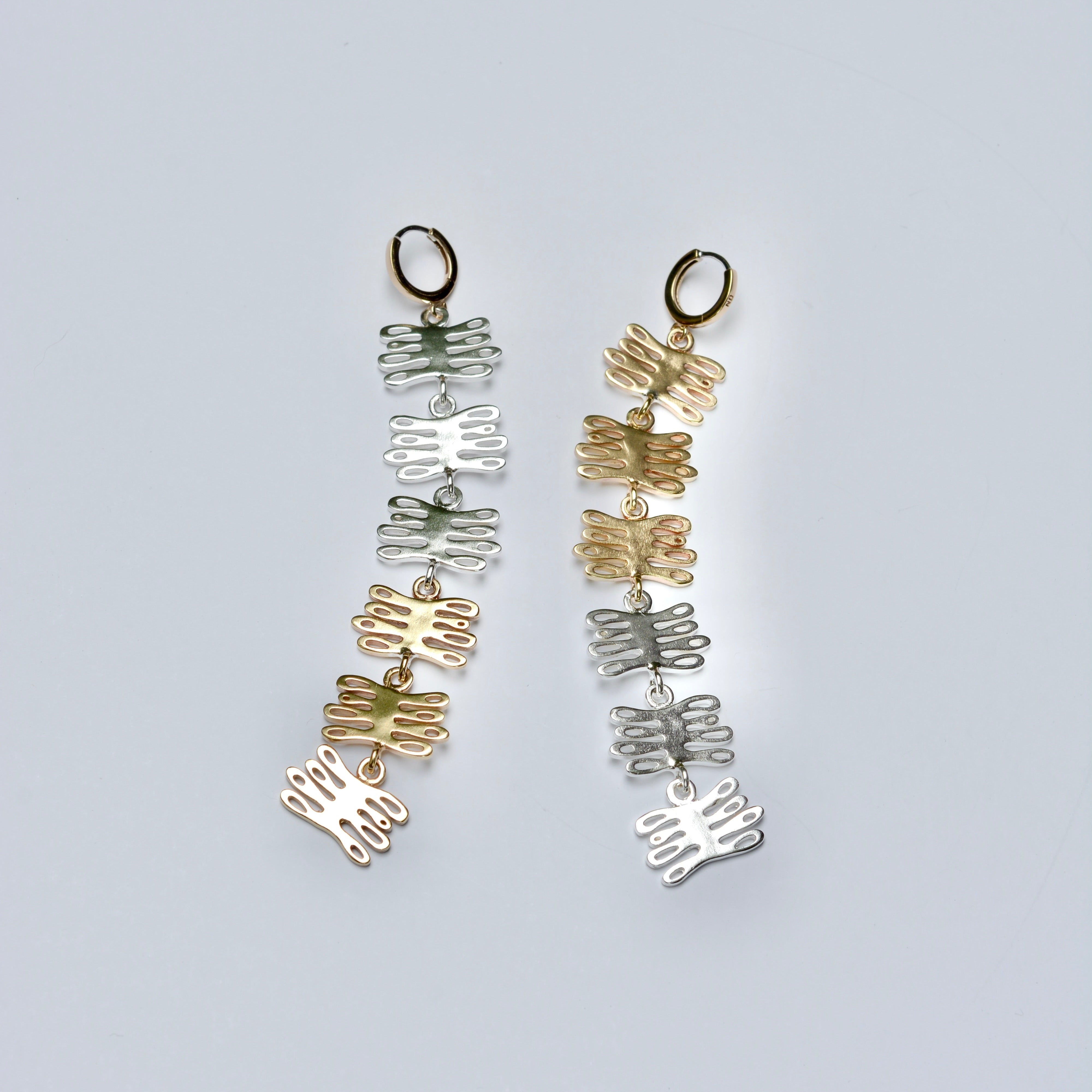 Dangly mixed metal earrings made of coral shaped charms 