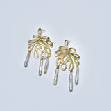 Bronze leaf earrings with pearl dangles on a light gray background