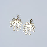 Bronze leaf-shaped earrings on a light gray background
