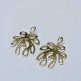 Bronze leaf-shaped earrings on a light gray background