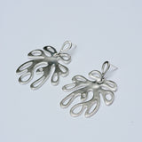 Silver leaf-shaped earrings on a light gray background