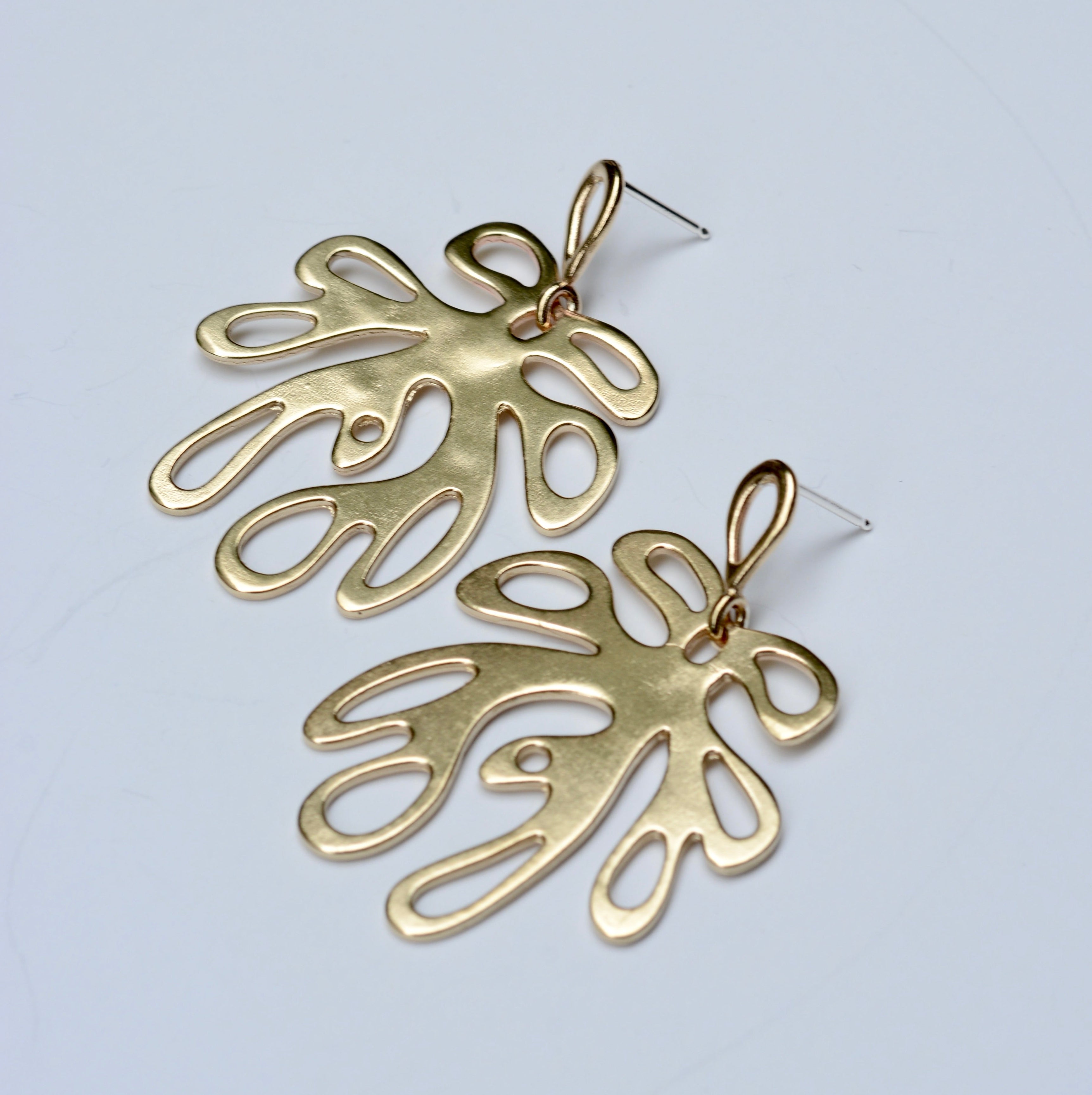 Bronze coral shaped earrings on a light gray background