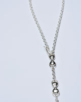 Silver necklace with a unique pendant on a light gray background