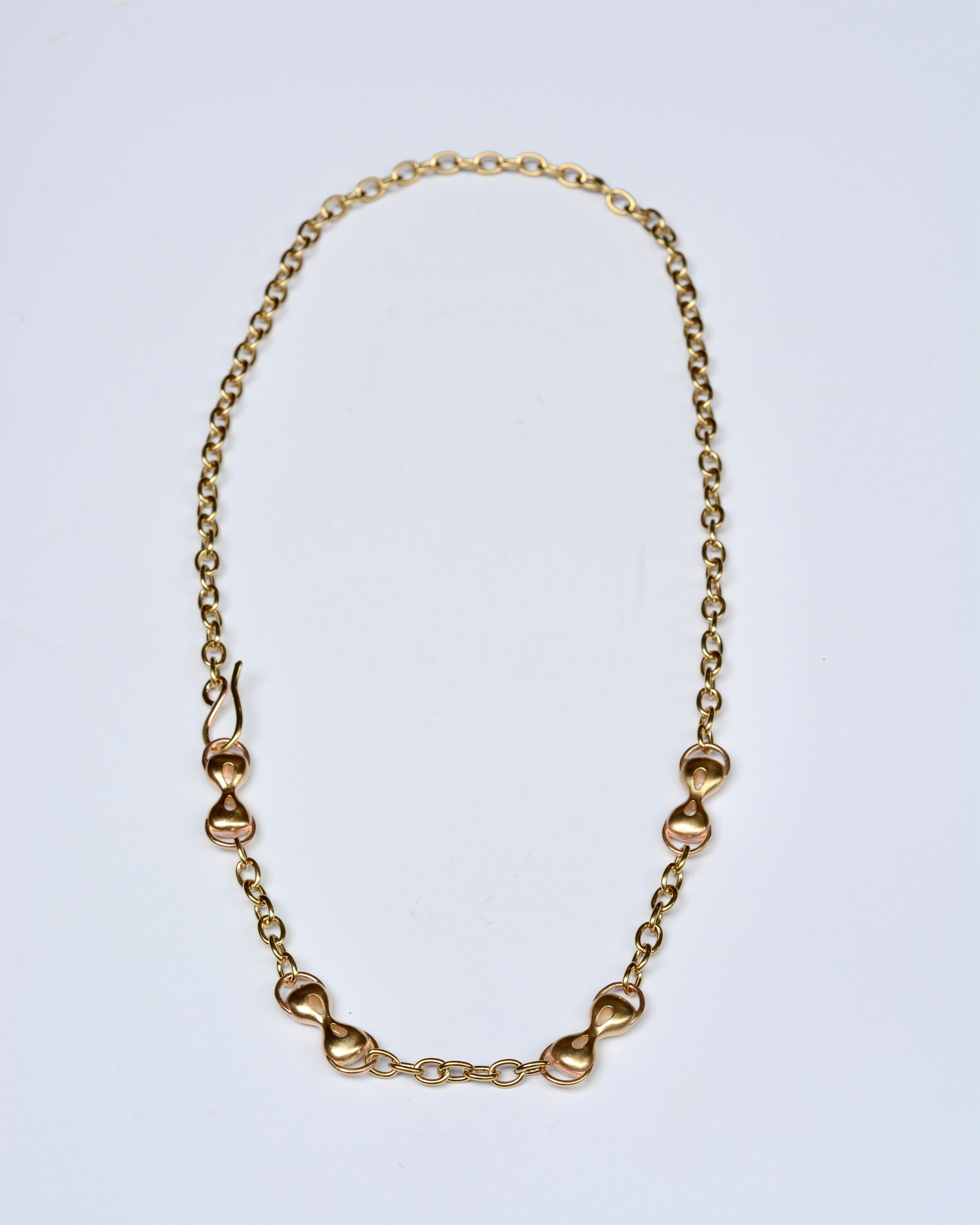 Bronze chain necklace on a light gray background