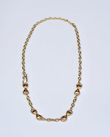 Bronze chain necklace on a light gray background