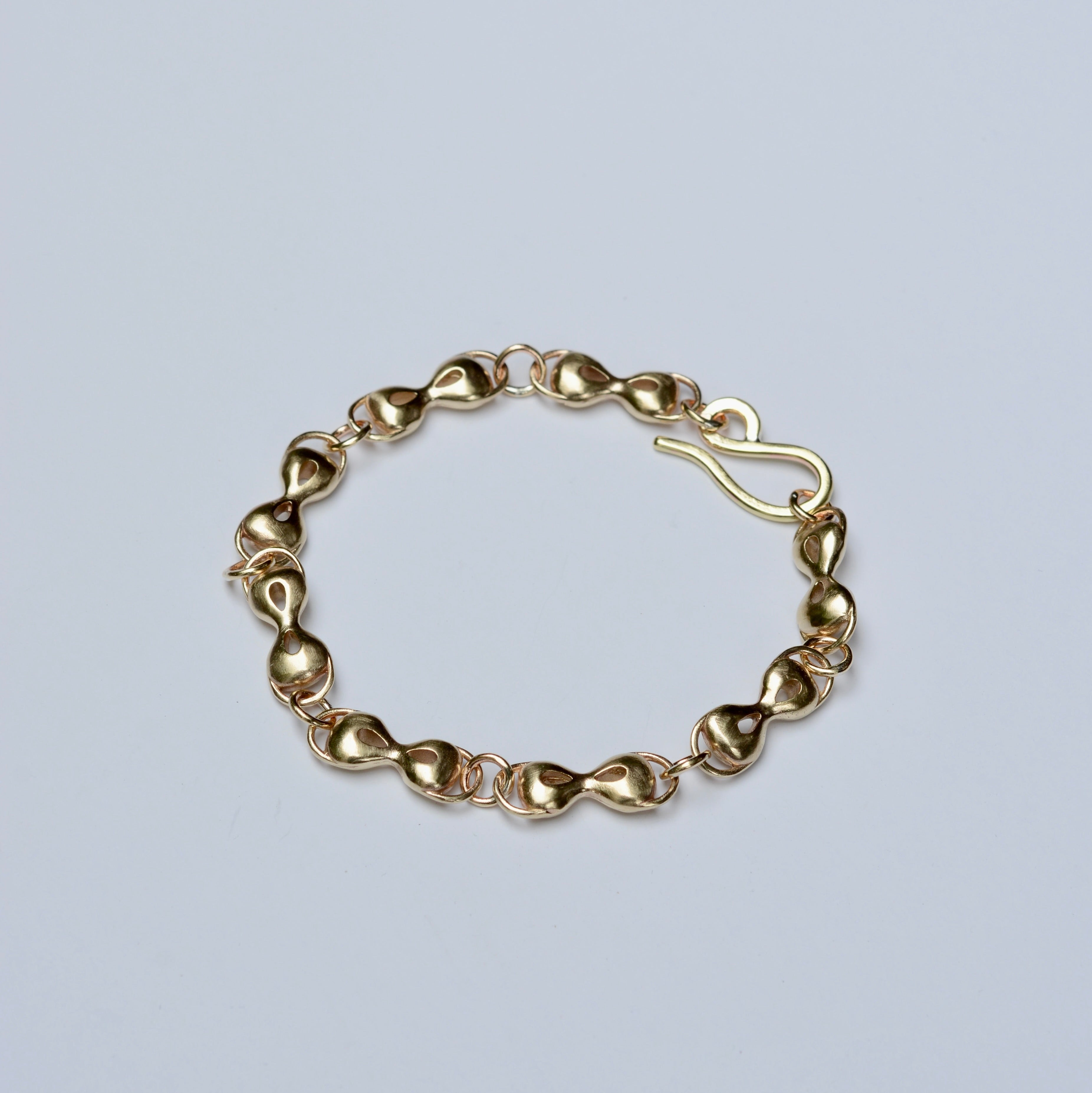 Bronze linked bracelet on a light gray background