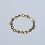 Bronze linked bracelet on a light gray background