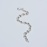 Silver chain bracelet on a light gray background