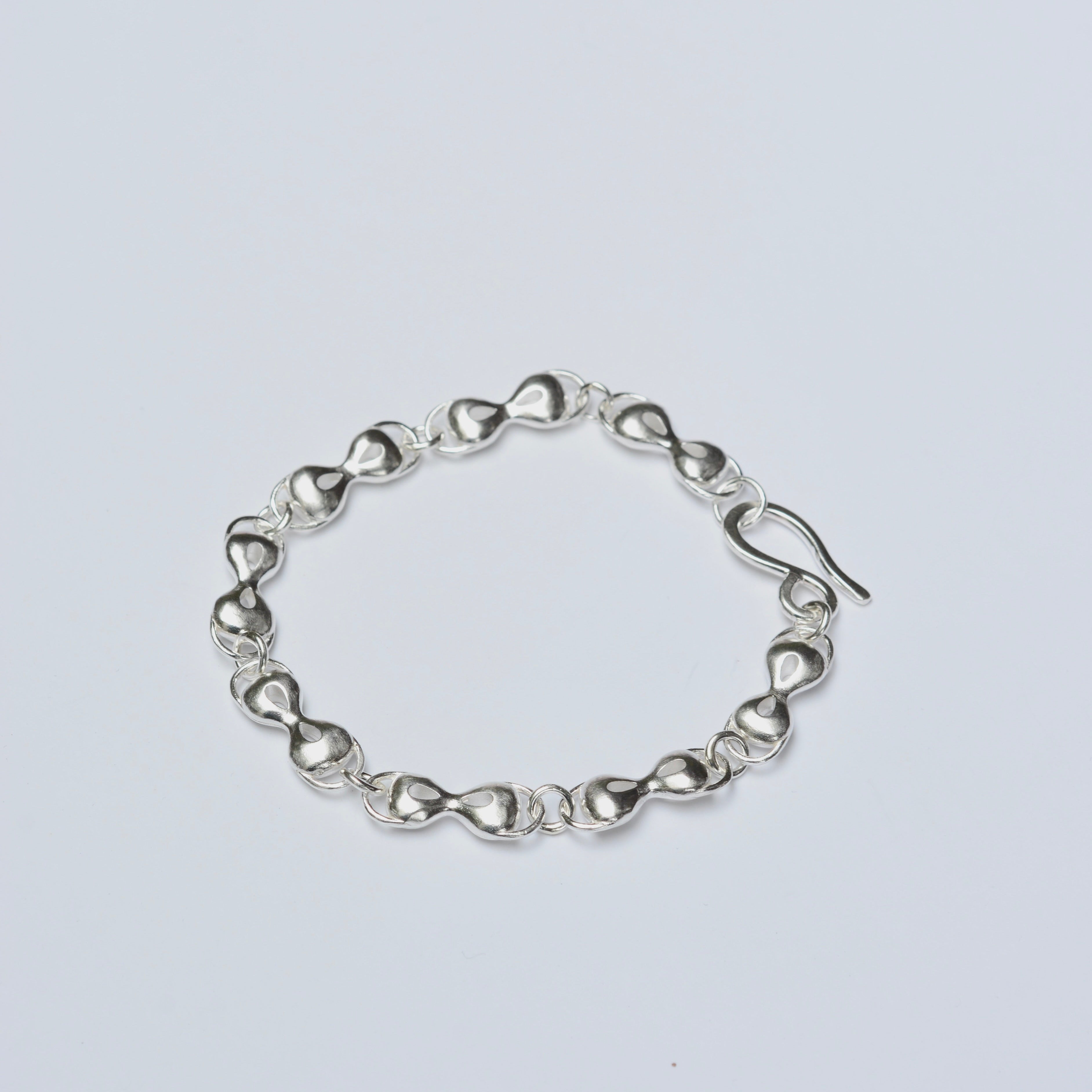 Silver bracelet on a light gray background