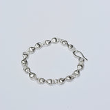 Silver bracelet on a light gray background