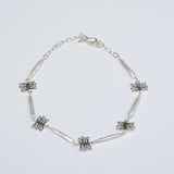 Silver necklace with kelp shaped charms and long white pearls