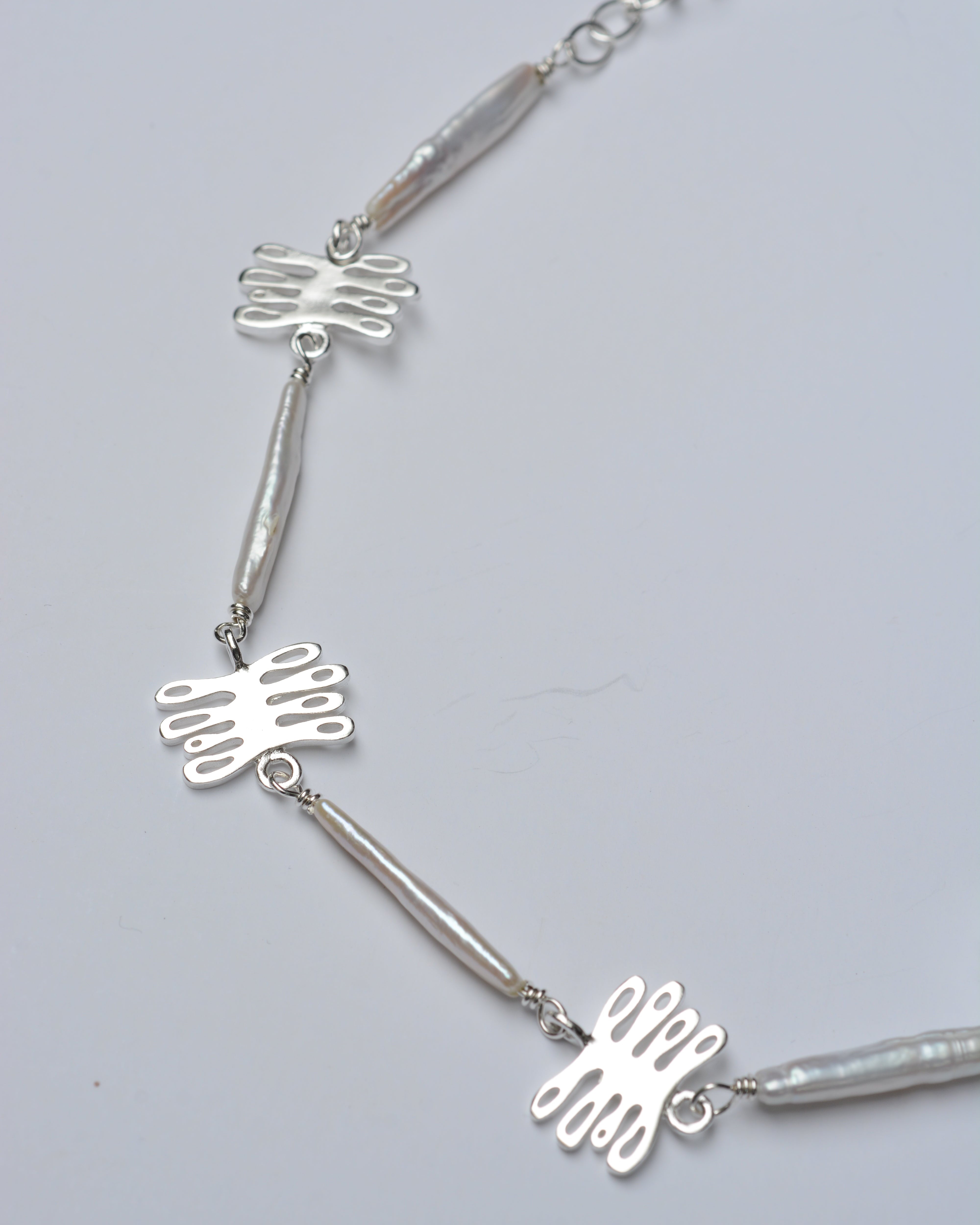 Sterling silver and pearl necklace with coral shaped pendants and long organic pearls