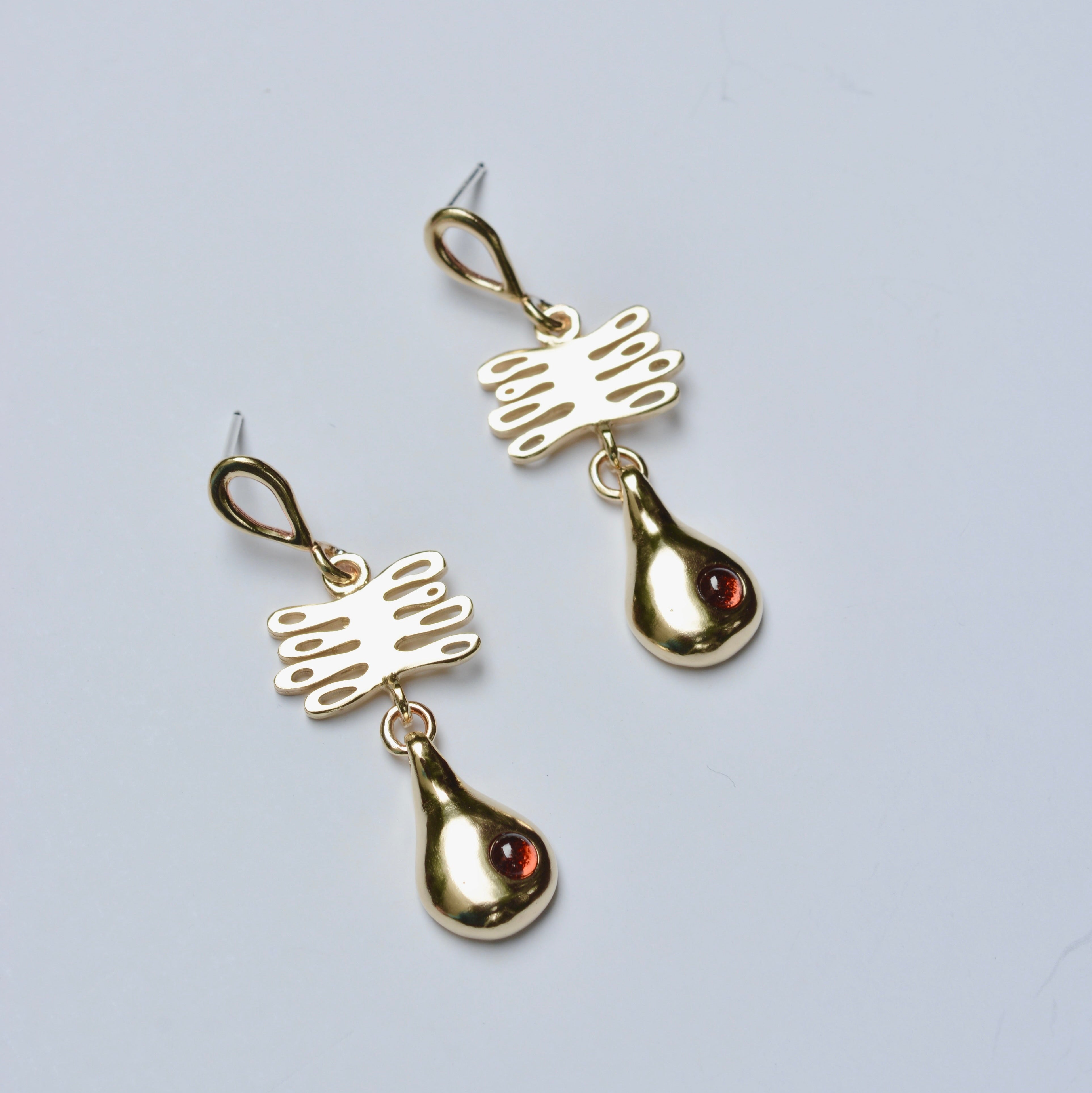 Bronze earrings with plant shaped charm and droplet featuring red garnet 