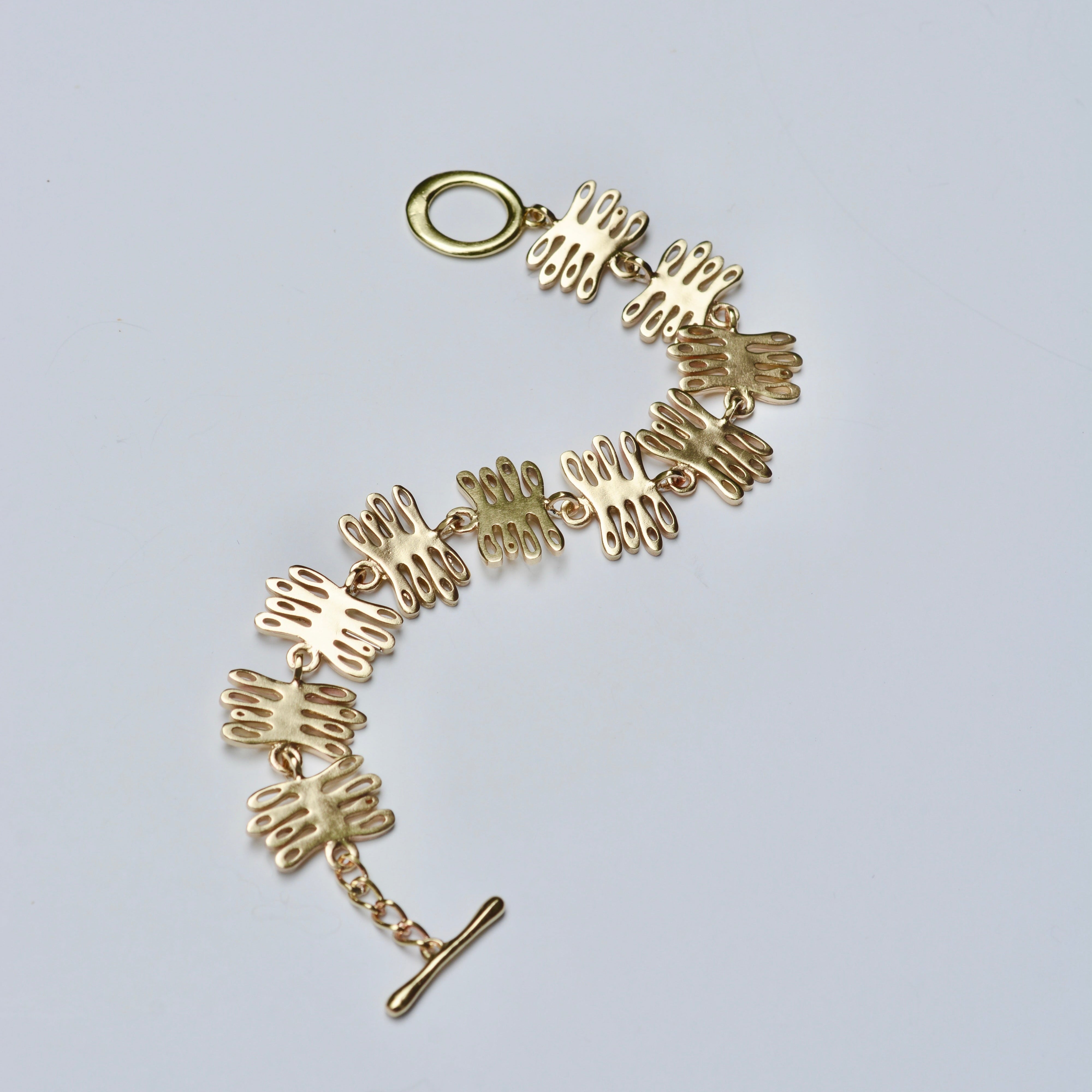 Bronze bracelet with unique design on a light gray background