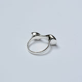 Sterling silver organic shaped ring on a grey background