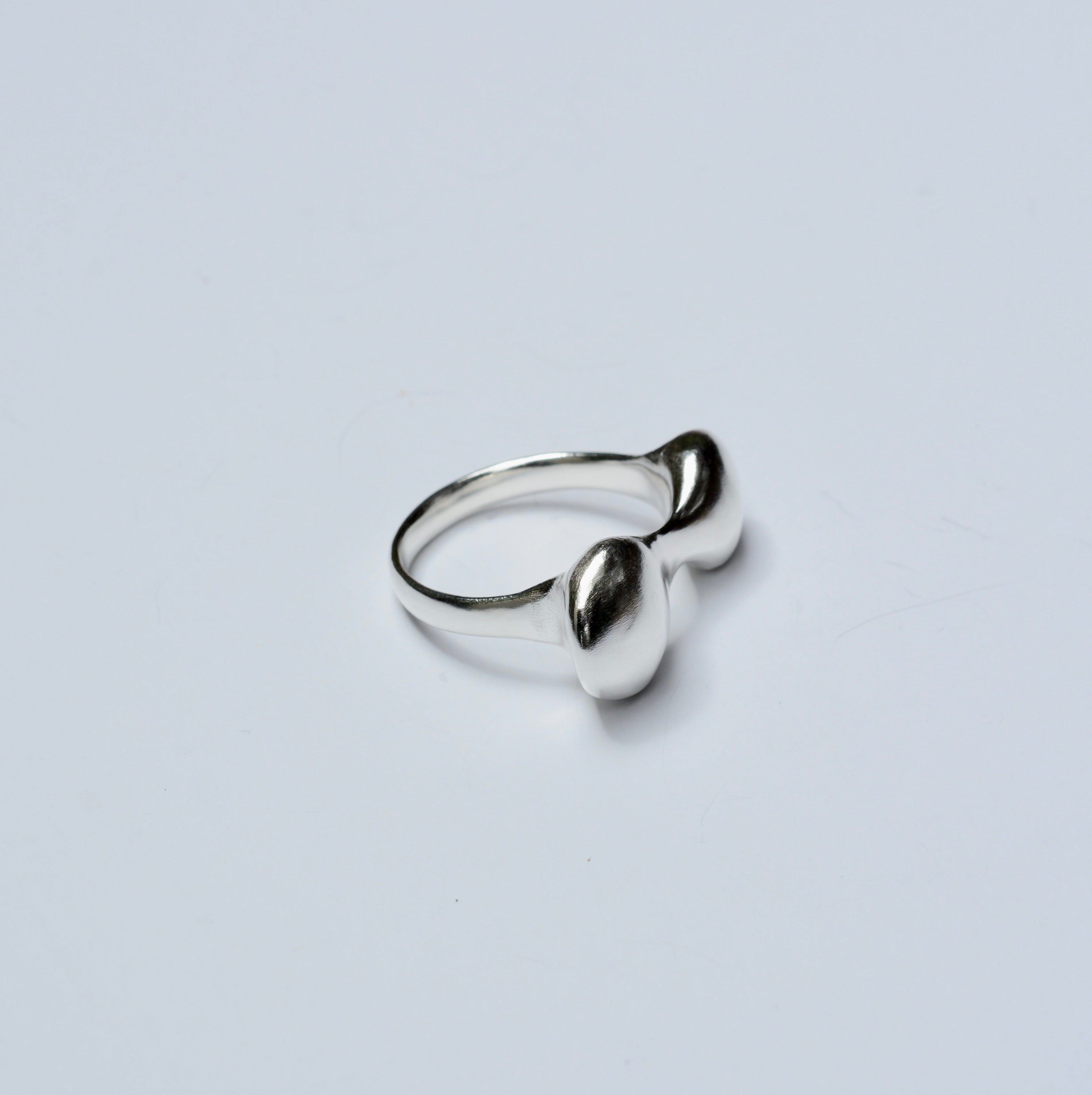 Silver ring on a light gray background
