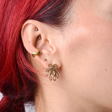 woman wearing a bronze wavy ear cuff and post of a coral shaped bronze earring.