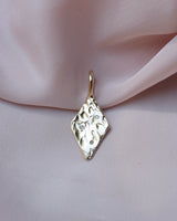 Diamond shaped pendant with organic texture and 3 flush set diamonds 