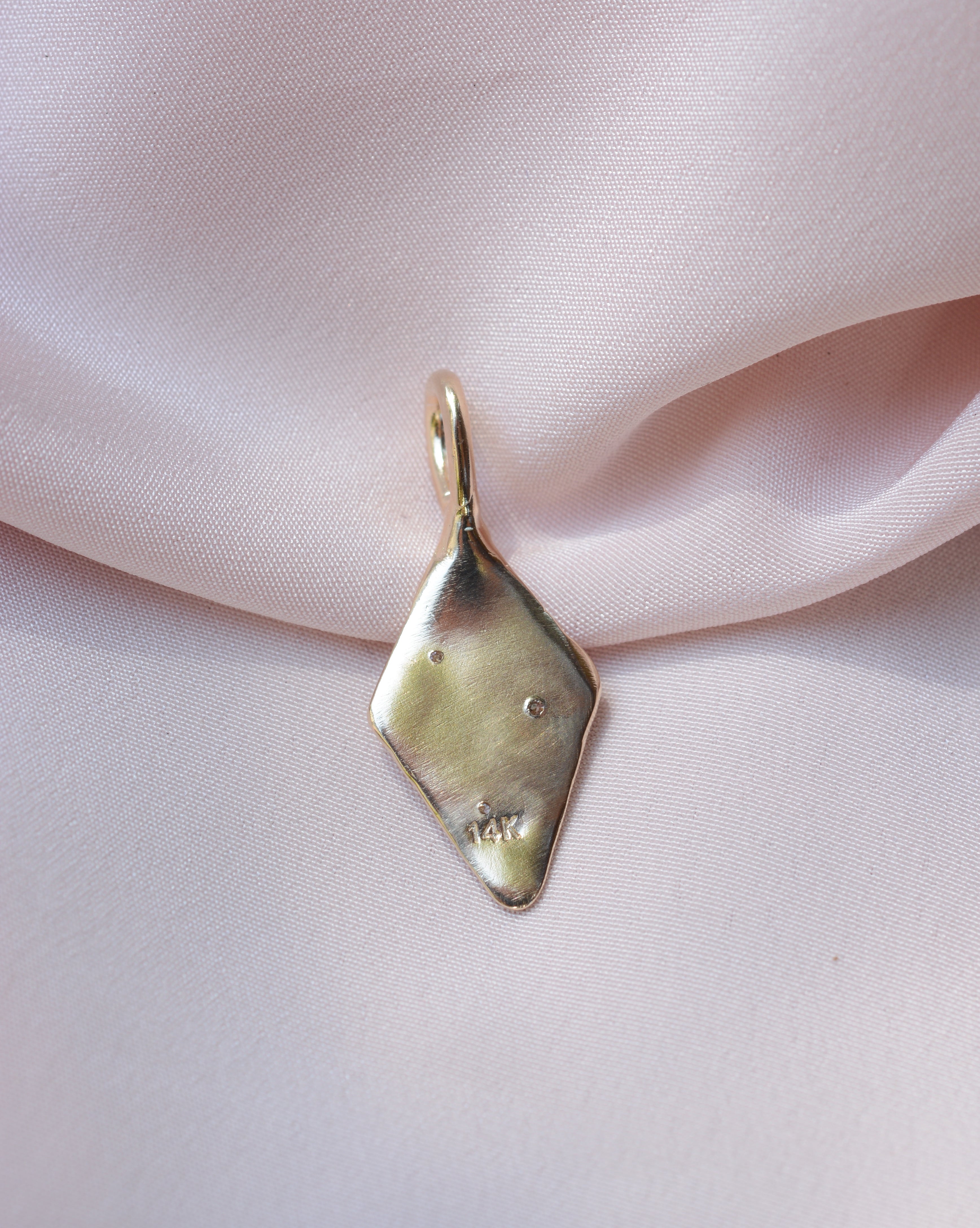 Backside of a pendant with 14k stamp