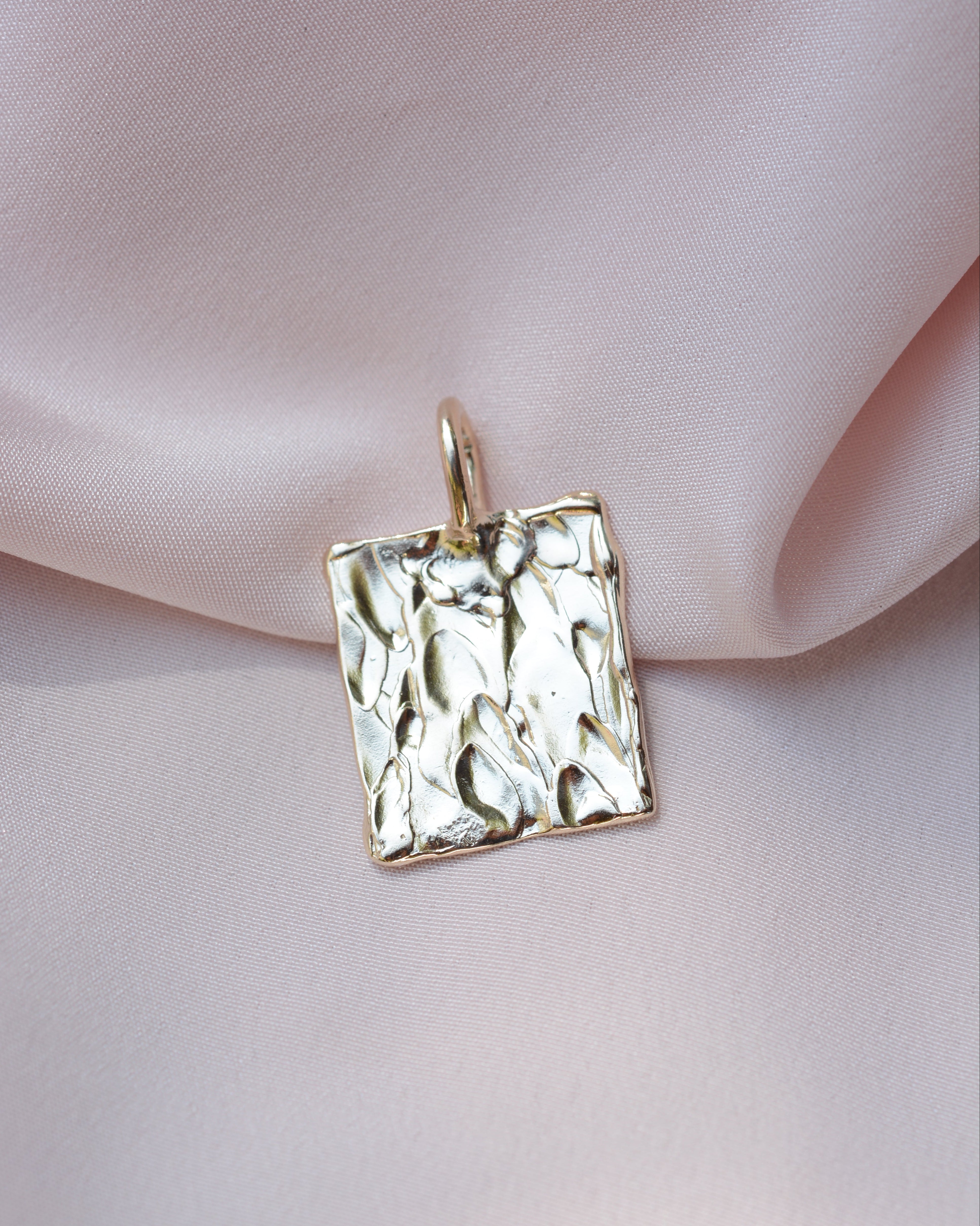 Gold rectangular pendant with organic bark like texture