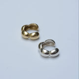 Bubble ear cuffs in silver and bronze on a grey background
