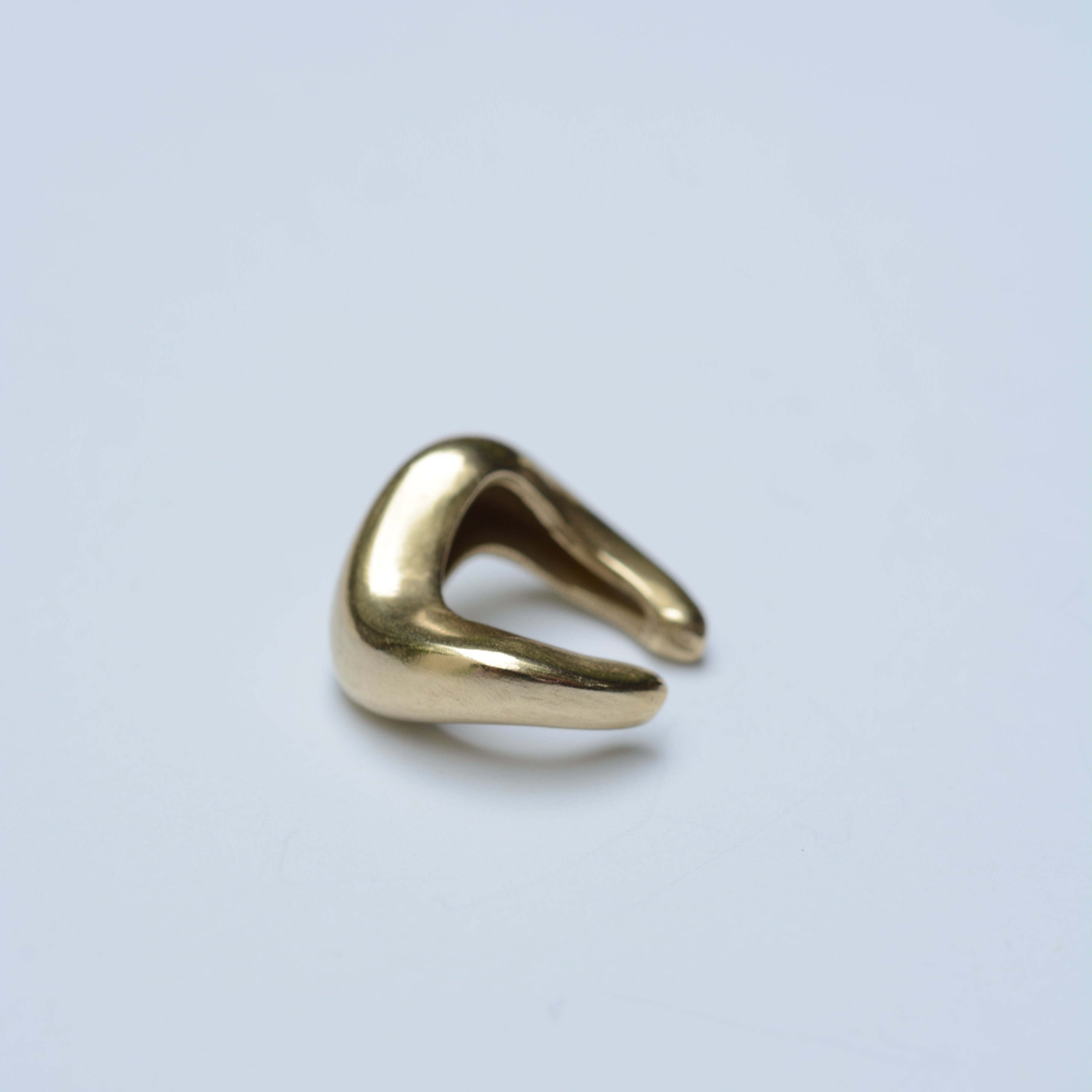 Back view of a wavy ear cuff in bronze