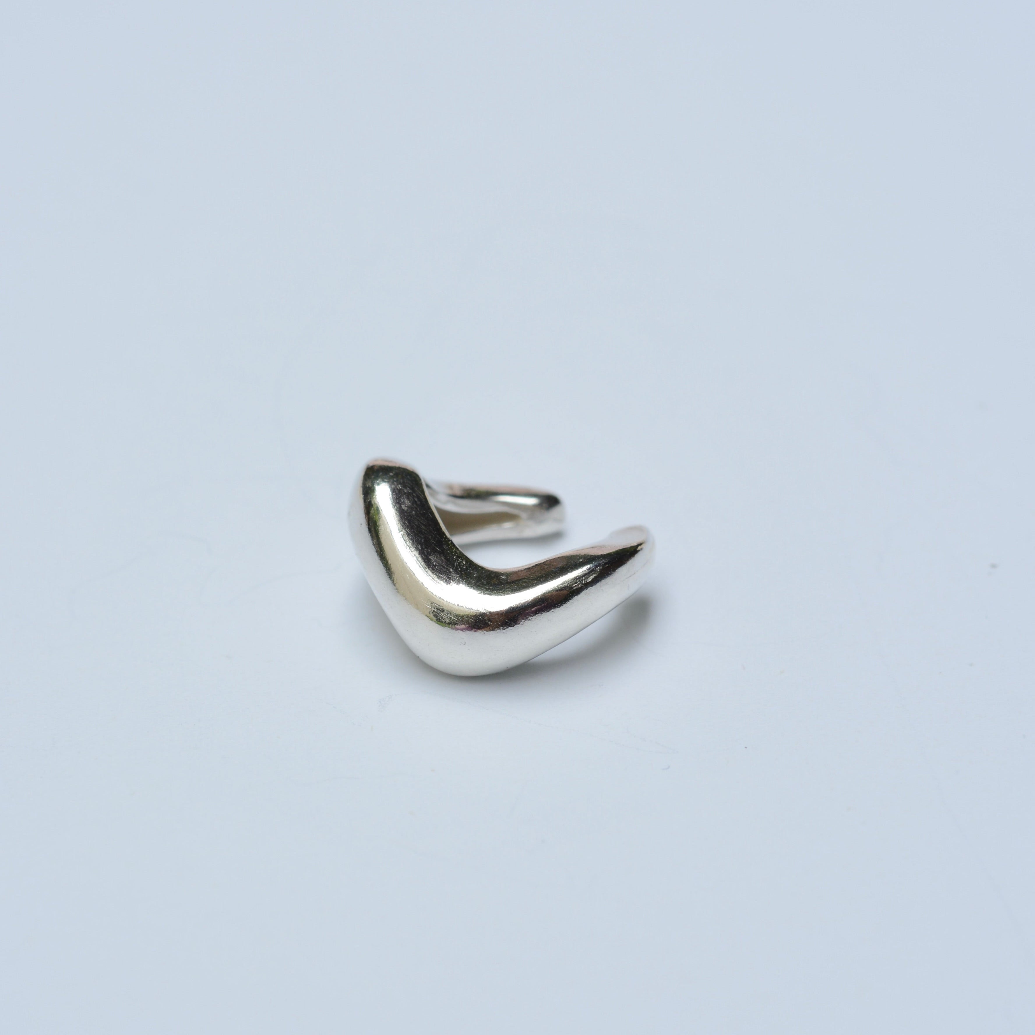 Silver ear cuff on a white background
