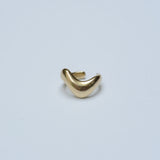 Bronze wavy ear cuff on a grey background