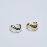 Two gold and silver open rings on a light gray background